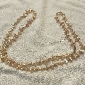 22 inch mother of pearl necklace. No clasp needs cleaning: item as is.
